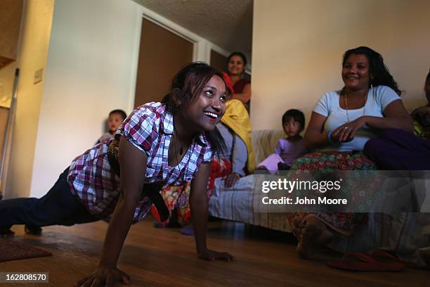 Bhutanese refugee Tulashi Darjee tries out an excercise regimen given by the International Rescue Committee , on February 27, 2013 in Tucson,...