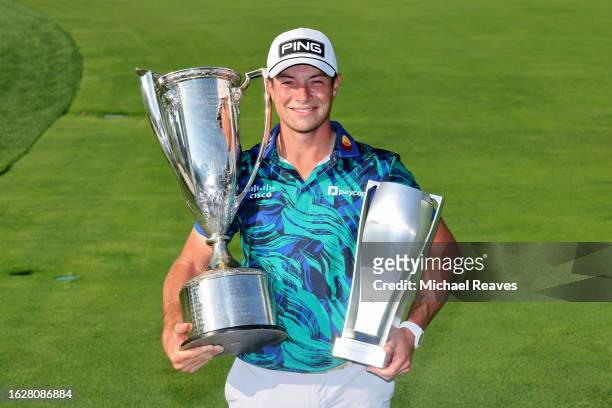 Viktor Hovland of Norway poses with The Western Golf Association Trophy and BMW Trophy after winning the BMW Championship at Olympia Fields Country...