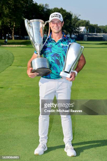 Viktor Hovland of Norway poses with The Western Golf Association Trophy and BMW Trophy after winning the BMW Championship at Olympia Fields Country...