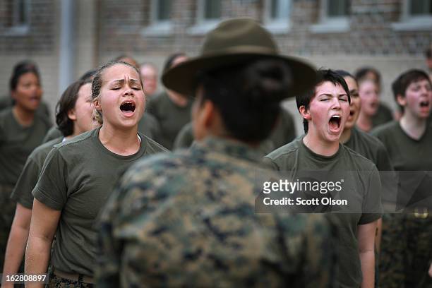 Drill Instructor SSgt. Jennifer Garza disciplines her Marine recruits with some unscheduled physical training in the sand pit outside their barracks...