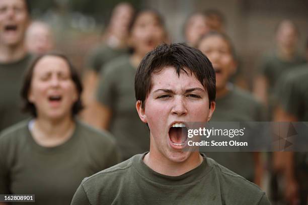 Female Marine recruits respond to their drill instructor as they are disciplined with some unscheduled physical training in the sand pit outside...