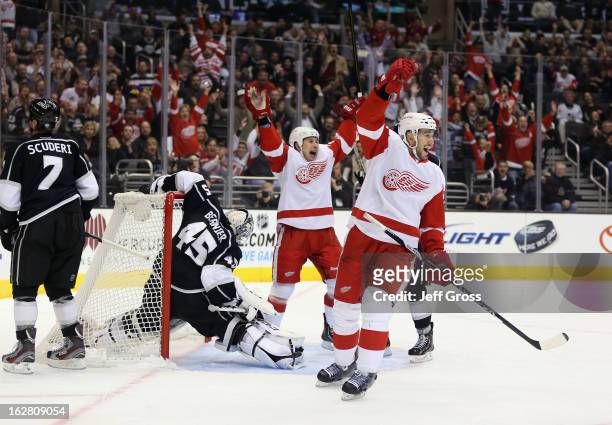 Jordin Tootoo and Drew Miller of the Detroit Red Wings celebrate a goal by teammate Kyle Quincey in the first period against the Los Angeles Kings at...