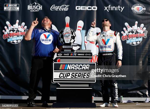 William Byron, driver of the Valvoline Chevrolet, and crew chief Rudy Fugle celebrate in victory lane after winning the NASCAR Cup Series Go Bowling...