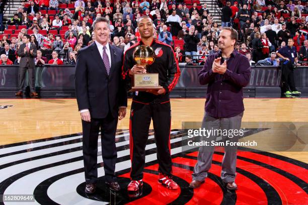 Damian Lillard of the Portland Trail Blazers receives his trophy for winning the NBA All-Star 2013 Taco Bell Skills Challenge before a game against...