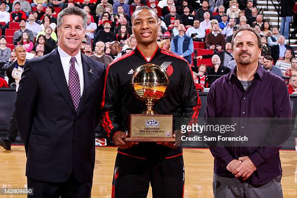 Damian Lillard of the Portland Trail Blazers receives his trophy for winning the NBA All-Star 2013 Taco Bell Skills Challenge before a game against...