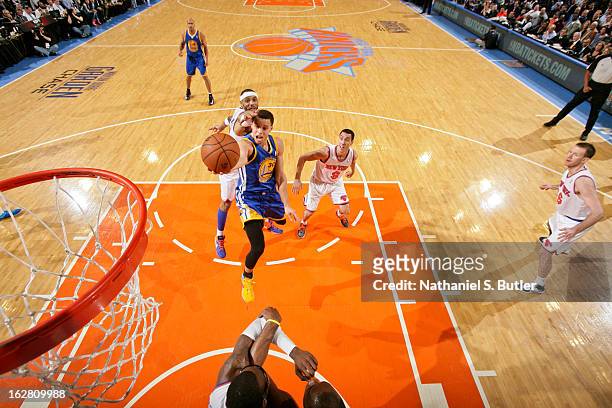 Stephen Curry of the Golden State Warriors attempts a layup against Kenyon Martin of the New York Knicks on February 27, 2013 at Madison Square...
