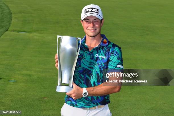 Viktor Hovland of Norway poses with the BMW Trophy after winning the BMW Championship at Olympia Fields Country Club on August 20, 2023 in Olympia...