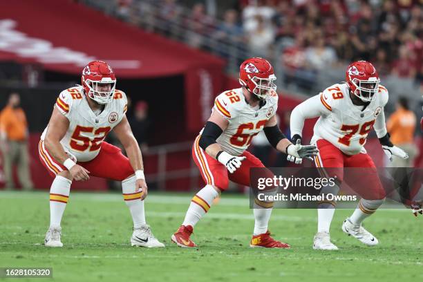 Creed Humphrey of the Kansas City Chiefs, Joe Thuney and Donovan Smith defend during an NFL preseason football game between the Arizona Cardinals and...