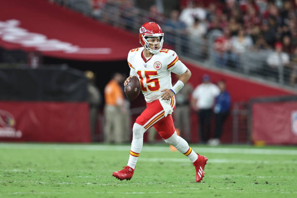 Patrick Mahomes of the Kansas City Chiefs scrambles and looks to pass during an NFL preseason football game between the Arizona Cardinals and the...