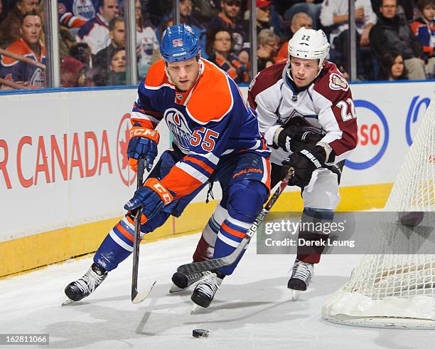 Ben Eager of the Edmonton Oilers skates against Matt Hunwick of the Colorado Avalanche during an NHL game at Rexall Place on February 16, 2013 in...