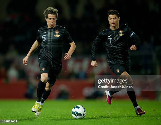 Cristiano Ronaldo of Portugal runs beside his teammate Fabio Coentrao controlling the ball during the international friendly match between Portugal...