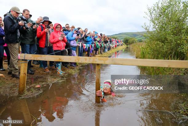 Competitor Louise Palmer dressed as Barbie takes part in the World Bog Snorkelling Championships held at the Waen Rhydd peat bog, Llanwrtyd Wells,...