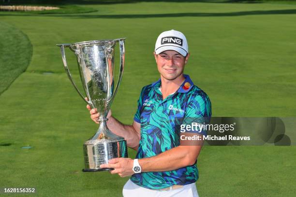 Viktor Hovland of Norway poses with the J.K. Wadley Trophy after winning the BMW Championship at Olympia Fields Country Club on August 20, 2023 in...