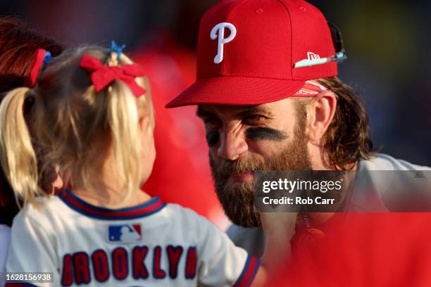 Bryce Harper of the Philadelphia Phillies talks with his daughter Brooklyn before the start of the 2023 Little League Classic against the Washington...