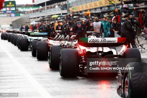 Drivers line up before restarting the race, after it was stopped during the Dutch Formula One Grand Prix race at The Circuit Zandvoort, in Zandvoort...