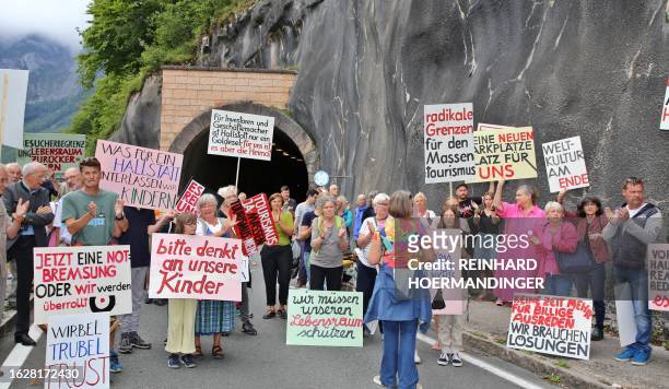 Locals protest against "overtourism" and block the road tunnel in the world-renowned sightseeing town of Hallstatt near Gmunden in Upper Austria on...