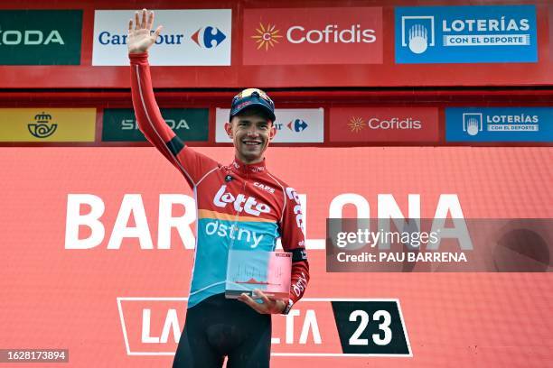 Team Lotto's Danish rider Andreas Lorentz Kron celebrates on the podium winning the second stage of the 2023 La Vuelta cycling tour of Spain, a 181,8...