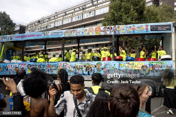 Revellers dance as a steel drum band play on the first day of Notting Hill Carnival on August 27, 2023 in London, England. The annual Caribbean...