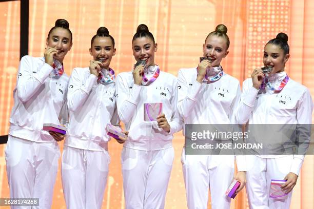 Silver medallists of Spain's group pose on the podium after the group 5 hoops final of the Olympic qualifier 40th FIG Rhythmic Gymnastics World...