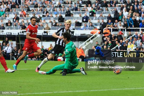 Anthony Gordon of Newcastle United scores the opening goal during the Premier League match between Newcastle United and Liverpool FC at St. James'...