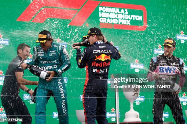 Second-placed Aston Martin's Spanish driver Fernando Alonso , first placed Red Bull Racing's Dutch driver Max Verstappen and third placed Alpine's...