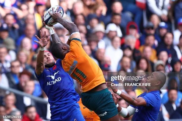 Australia's wing Suli Vunivalu catches the ball ahead of France's wing Gabin Villière and France's inside centre Gael Fickou during the pre-World Cup...
