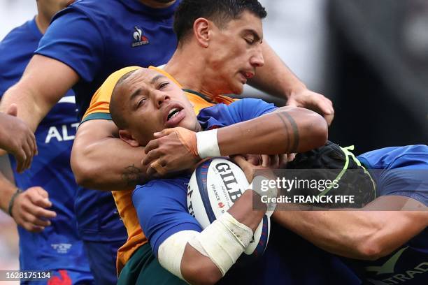 France's inside centre Gael Fickou is tackled by Australia's centre Lalakai Foketi during the pre-World Cup rugby union international Test match...