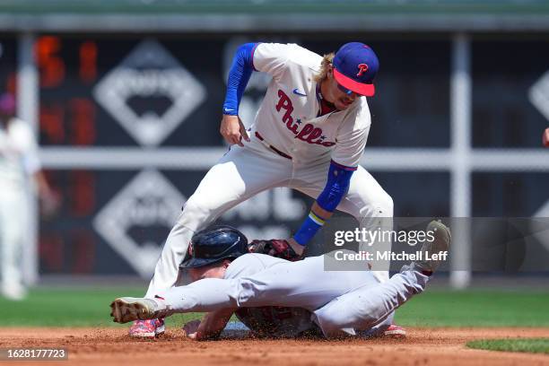 Bryson Stott of the Philadelphia Phillies tags out Tommy Edman of the St. Louis Cardinals in the top of the first inning at Citizens Bank Park on...