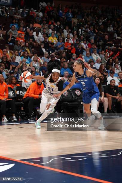 Jordin Canada of the Los Angeles Sparks dribbles the ball during the game against the Connecticut Sun on August 27, 2023 at the Mohegan Sun Arena in...