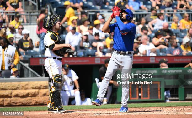 Jeimer Candelario of the Chicago Cubs reacts as he crosses home plate after hitting a two run home run in the fourth inning during the game against...