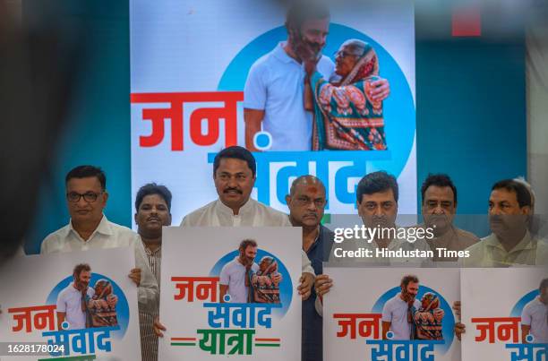 Maharashtra Pradesh Congress Committee President Nana Patole, party leaders Ashok Chavan and Balasaheb Thorat hold a placard during a press...