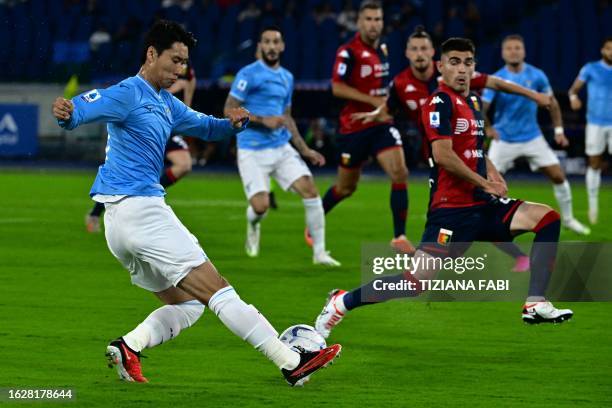 Lazio's Japanese midfielder Daichi Kamada fights for the ball with Genoa's Mexican defender Johan Vasquez during the Italian Serie A football match...