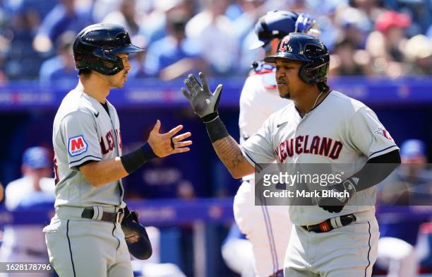 Jose Ramirez of the Cleveland Guardians celebrates his two run home run with Steven Kwan against the Toronto Blue Jays during the third inning in...