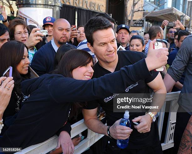 Mark Wahlberg poses with fans at Extra at The Grove on February 27, 2013 in Los Angeles, California.