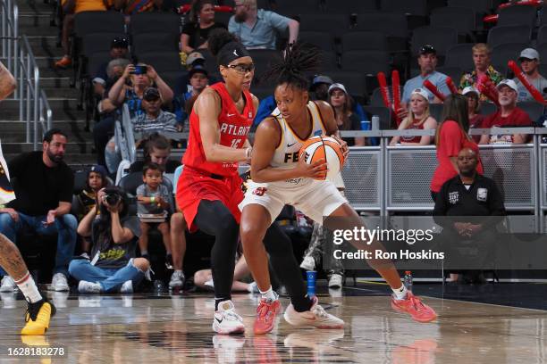 Kelsey Mitchell of the Indiana Fever handles the ball during the game against the Atlanta Dream on August 27, 2023 at Gainbridge Fieldhouse in...