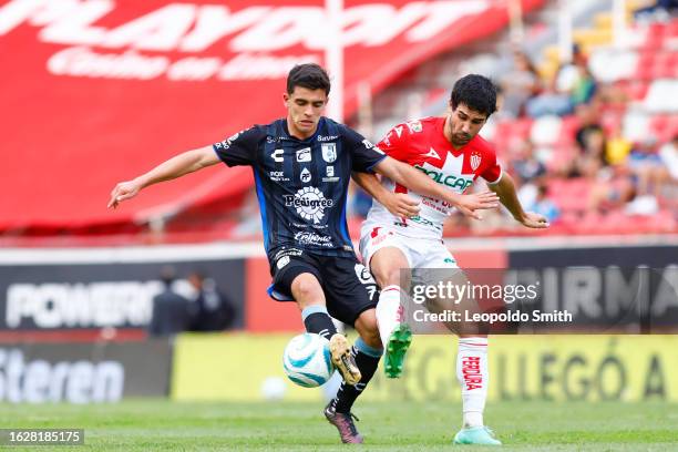 Rodrigo Lopez of Queretaro competes for the ball with Vicente Poggi of Necaxa during the 6th round match between Necaxa and Queretaro as part of...
