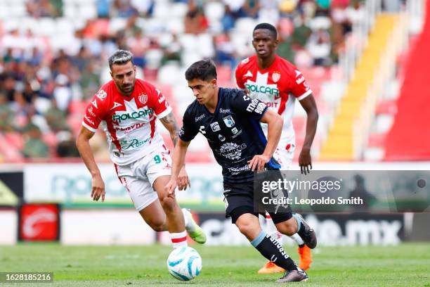 Rodrigo Lopez of Queretaro competes for the ball with Facundo Batista of Necaxa during the 6th round match between Necaxa and Queretaro as part of...