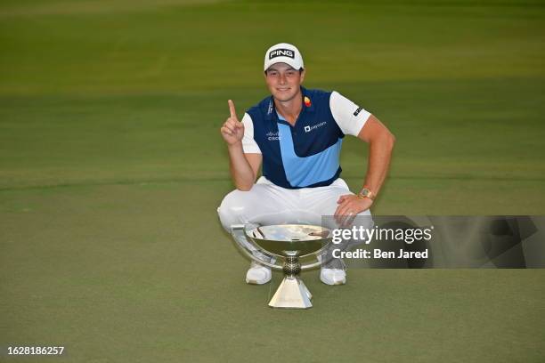 Viktor Hovland of Norway poses with the FedEx Cup Trophy after putting in to win on the 18th green during the final round of the TOUR Championship at...