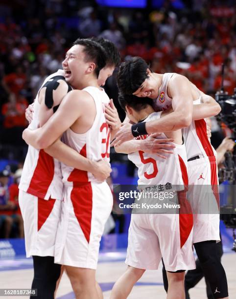 Japan players celebrate after defeating Finland in a FIBA Basketball World Cup Group E game at Okinawa Arena in Okinawa, southern Japan, on Aug. 27,...