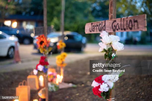 Candles burn at memorials for Jerrald Gallion, Angela Carr and Anolt Joseph Laguerre Jr. Near a Dollar General store where they were shot and killed...