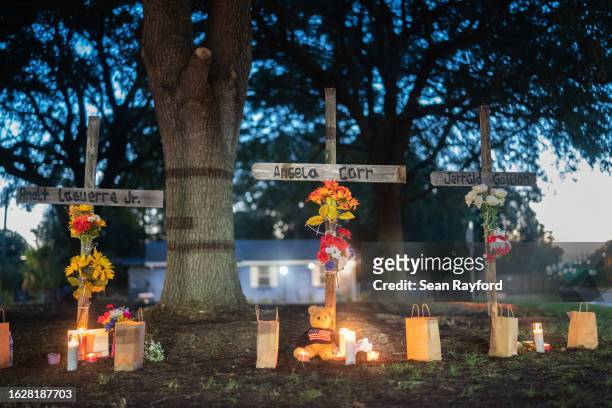 Candles burn at memorials for Angela Carr, Anolt Joseph Laguerre Jr. And Jerrald Gallion near a Dollar General store where they were shot and killed...
