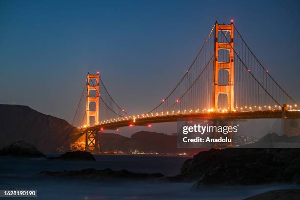 Golden Gate Bridge is seen after sunset from Baker Beach in San Francisco California, United States on August 27, 2023.