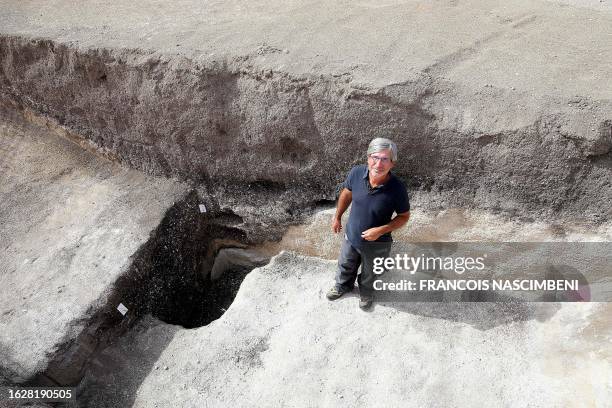 Remi Martineau, researcher at the CNRS, stands at the mouth of a well, dating from the Modern Neolithic, around 3500-years-ago, from a settlement...