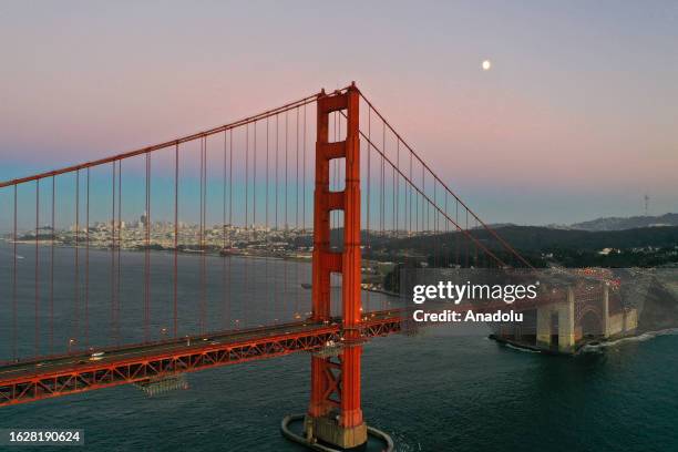 An aerial view of Golden Gate Bridge after sunset from Baker Beach in San Francisco California, United States on August 27, 2023.