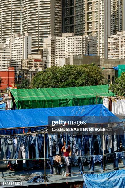 In this picture taken on August 26 a worker puts clothes out for drying at an open-air laundromat, locally called 'Dhobi Ghat' in Mumbai.