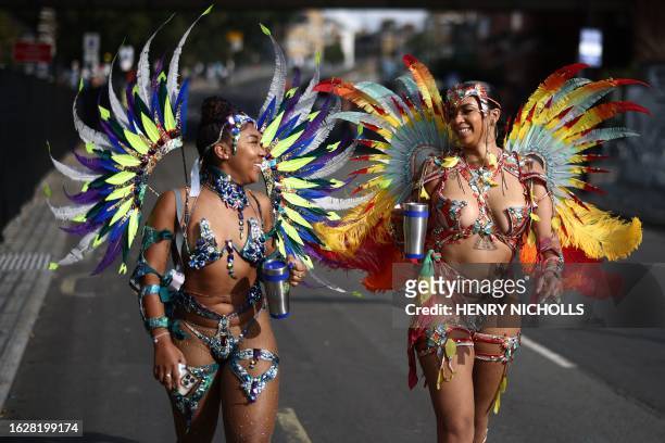 Performers in costume arrive to take part in the main Parade Day of the Notting Hill Carnival in west London on August 27, 2023.