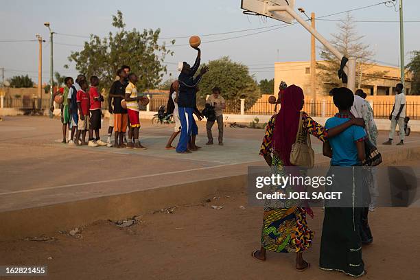 Coach Oumar Tonko Cisse attends a training session with young players of basketball at the former "Sharia Square" in central Gao on February 26,...