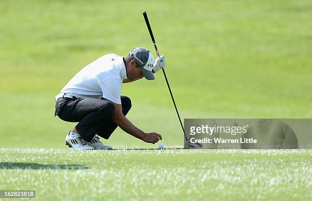 Steve Webster of England marks his ball as pick and place is in operation during the first round of the Tshwane Open at Copperleaf Golf & Country...