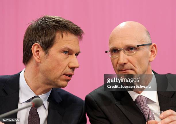 Deutsche Telekom AG chief executive officer Rene Obermann and chief financial officer Timotheus Hoettges attend the company's annual press conference...