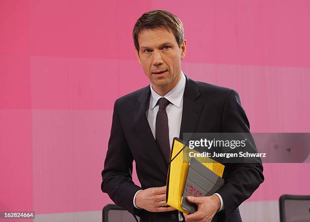 Deutsche Telekom AG chief executive officer Rene Obermann leaves the company's annual press conference after announcing the financial results for...